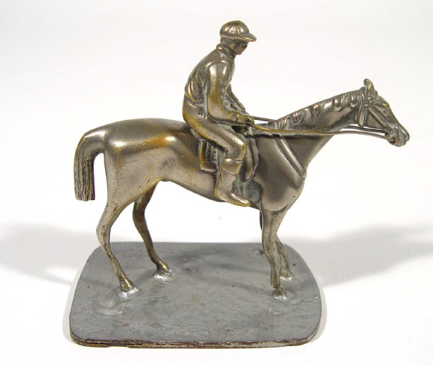 Appraisal: Silvered metal horse racing mascot a jockey on horseback cm