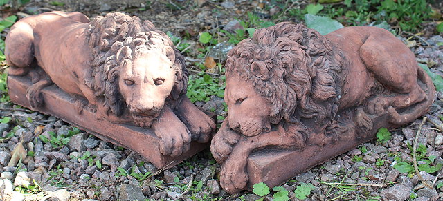 Appraisal: A PAIR OF CAST TERRACOTTA COLOURED LIONS after originals by