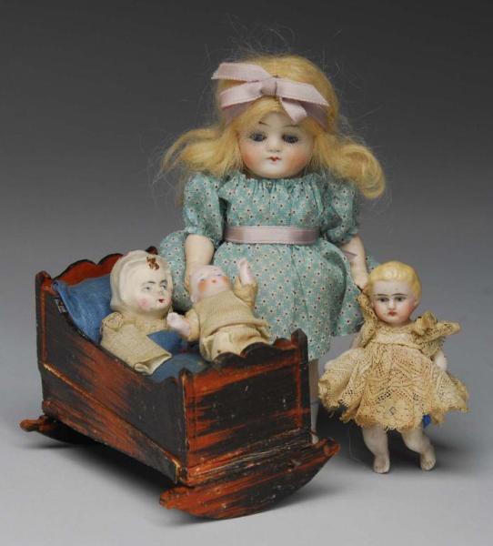 Appraisal: Papier-Mache Squeak Toy and All-Bisque Dolls Description Germany to Early