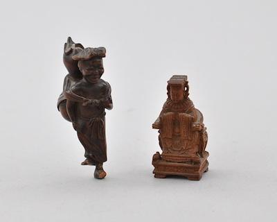 Appraisal: Two Wood Netsukes Carved dark wood standing figure of a