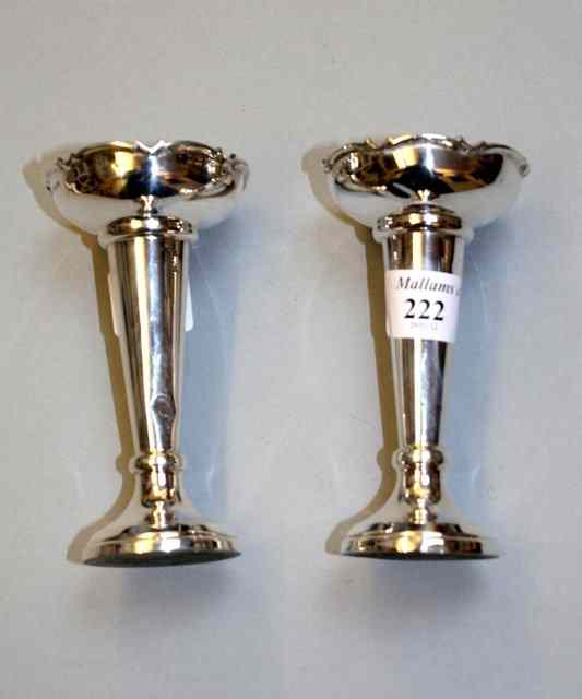 Appraisal: A PAIR OF SILVER POSY VASES with shaped edges flared