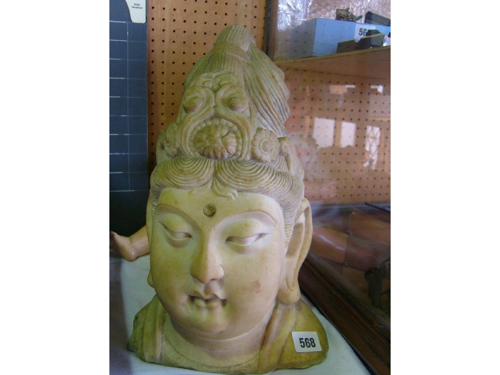 Appraisal: A white marble head of a Buddha with combed hair