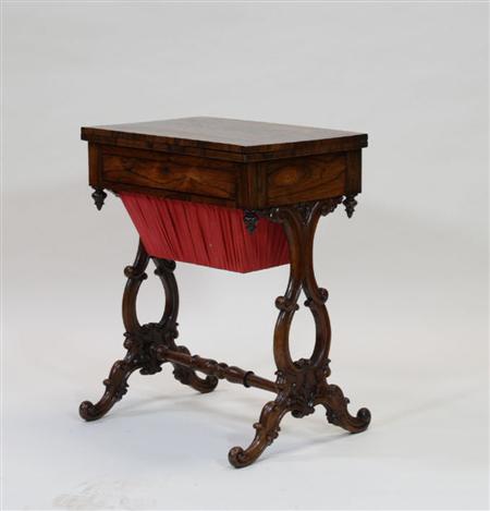 Appraisal: A Victorian rosewood work table the rectangular flip-top over a