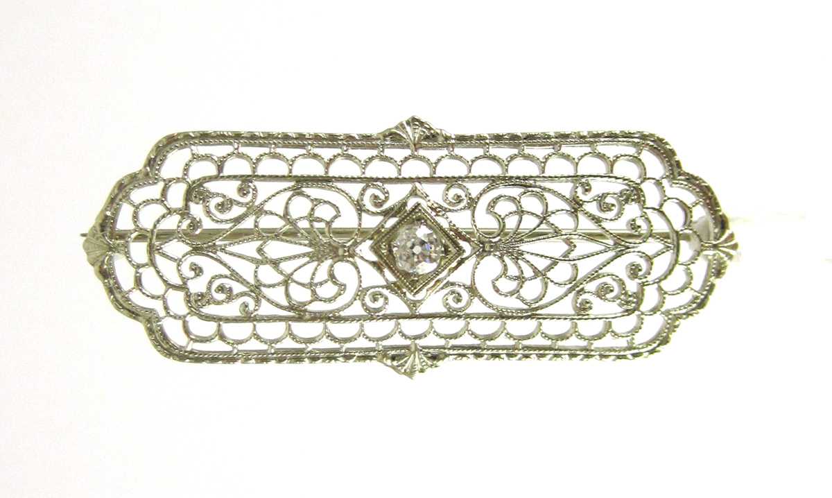 Appraisal: DIAMOND AND TEN KARAT GOLD FILIGREE PIN The white gold