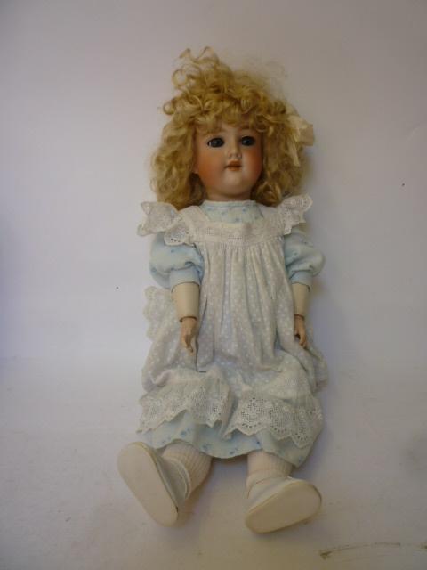 Appraisal: An Armand Marseille bisque head girl doll with blue glass