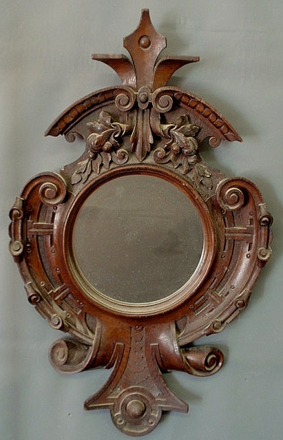 Appraisal: Extensively carved walnut Victorian mirror with scrolled sides and base