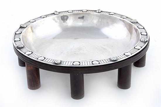 Appraisal: Silver metal centerbowl on wood stand Latin-American influenced design with