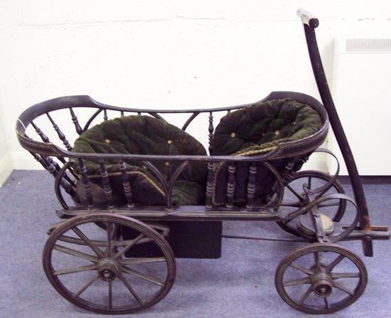 Appraisal: A Victorian double seat children's carriage the backs with spindle