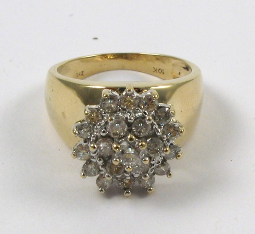 Appraisal: DIAMOND AND FOURTEEN KARAT GOLD RING centering a cluster of