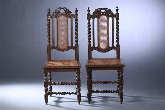 Appraisal: PAIR RENAISSANCE REVIVAL OAK HALL CHAIRS th century Carved crest