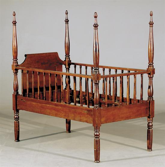 Appraisal: American mixed wood youth bed th centuryturned posts supporting paneled