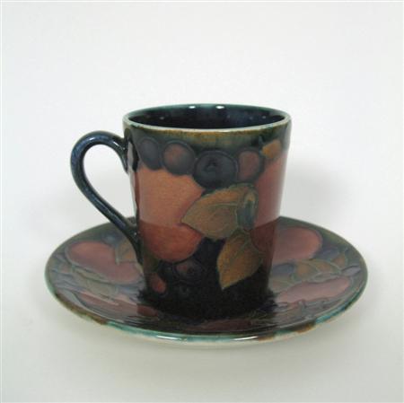 Appraisal: MOORCROFT COFFEE CAN SAUCER CIRCA glazed earthenware decorated in tube