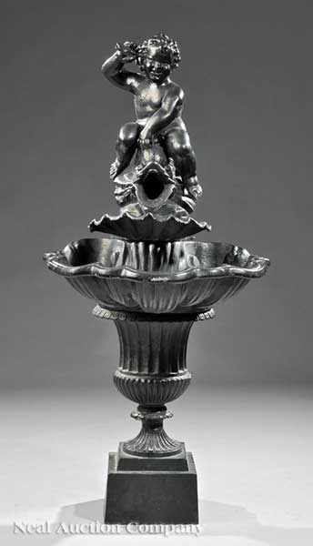 Appraisal: An Antique Lead Figural Garden Fountain cherub riding a dolphin