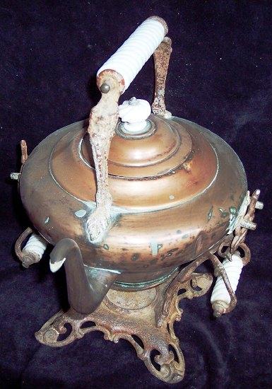 Appraisal: A copper spirit kettle on stand the opaque glass handles