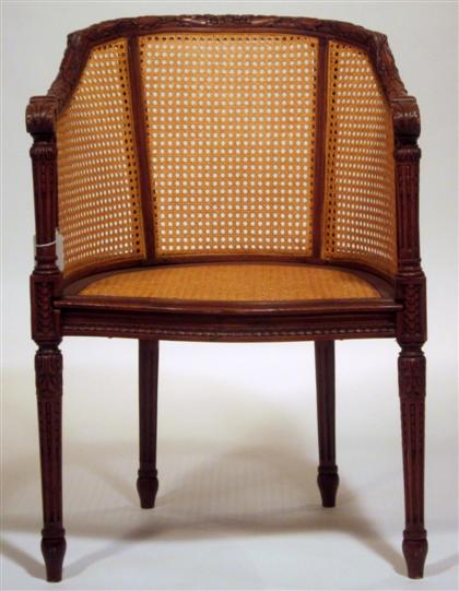 Appraisal: French carved walnut and rattan bergere early th century