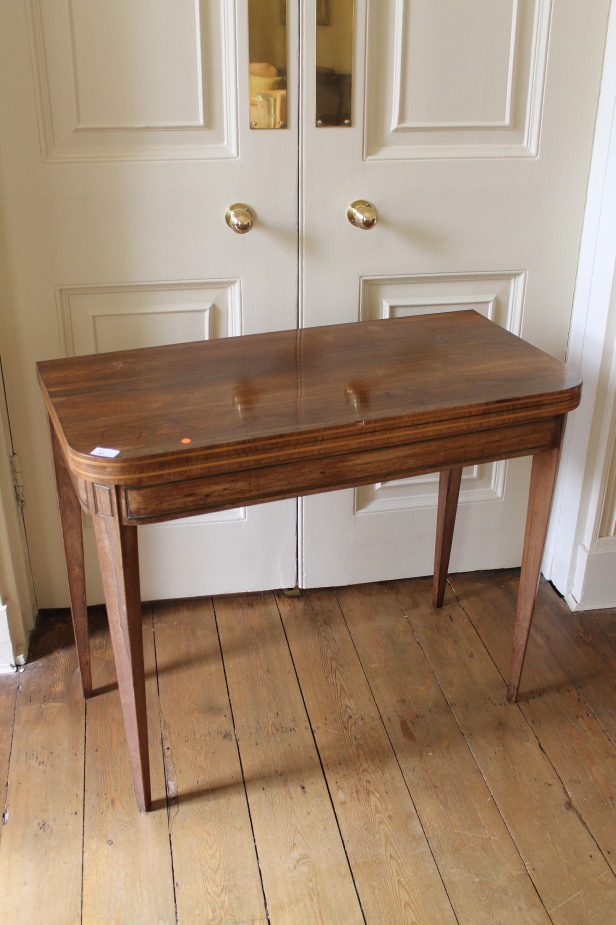 Appraisal: A Regency rosewood card table with rounded rectangular folding top