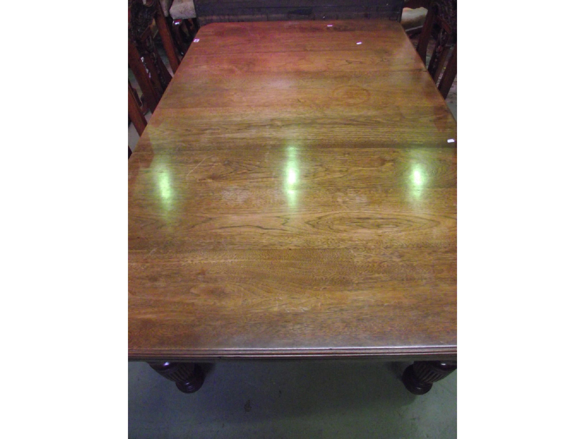 Appraisal: An Edwardian mahogany wind-out extending dining table of rectangular form