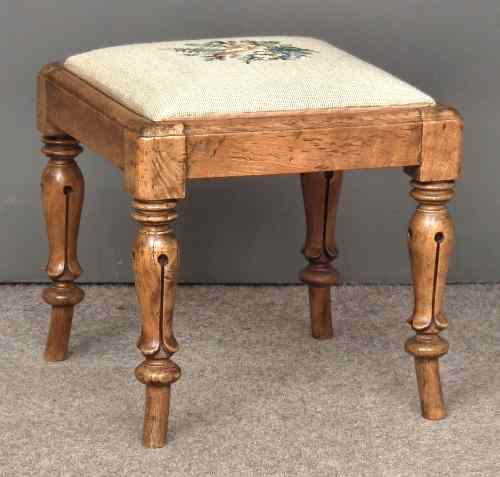 Appraisal: A walnut square stool the drop-in seat upholstered in needlework