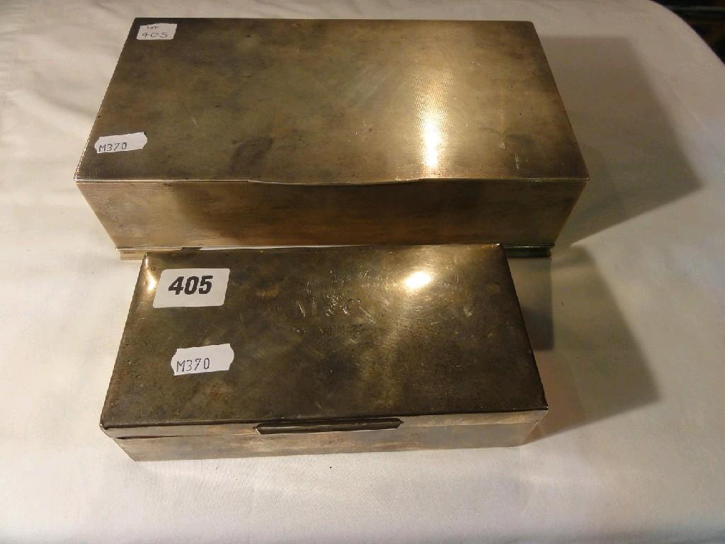 Appraisal: A substantial silver cigarette box on ogee supports with engine