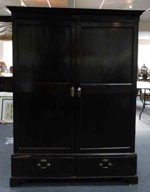 Appraisal: A George III mahogany wardrobe fitted two panel doors