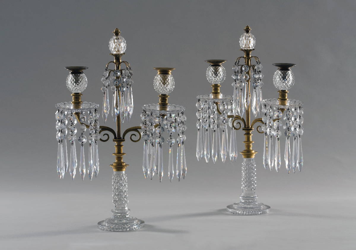 Appraisal: PAIR OF REGENCY CUT-GLASS AND BRASS TWO-LIGHT CANDELABRA Each standard