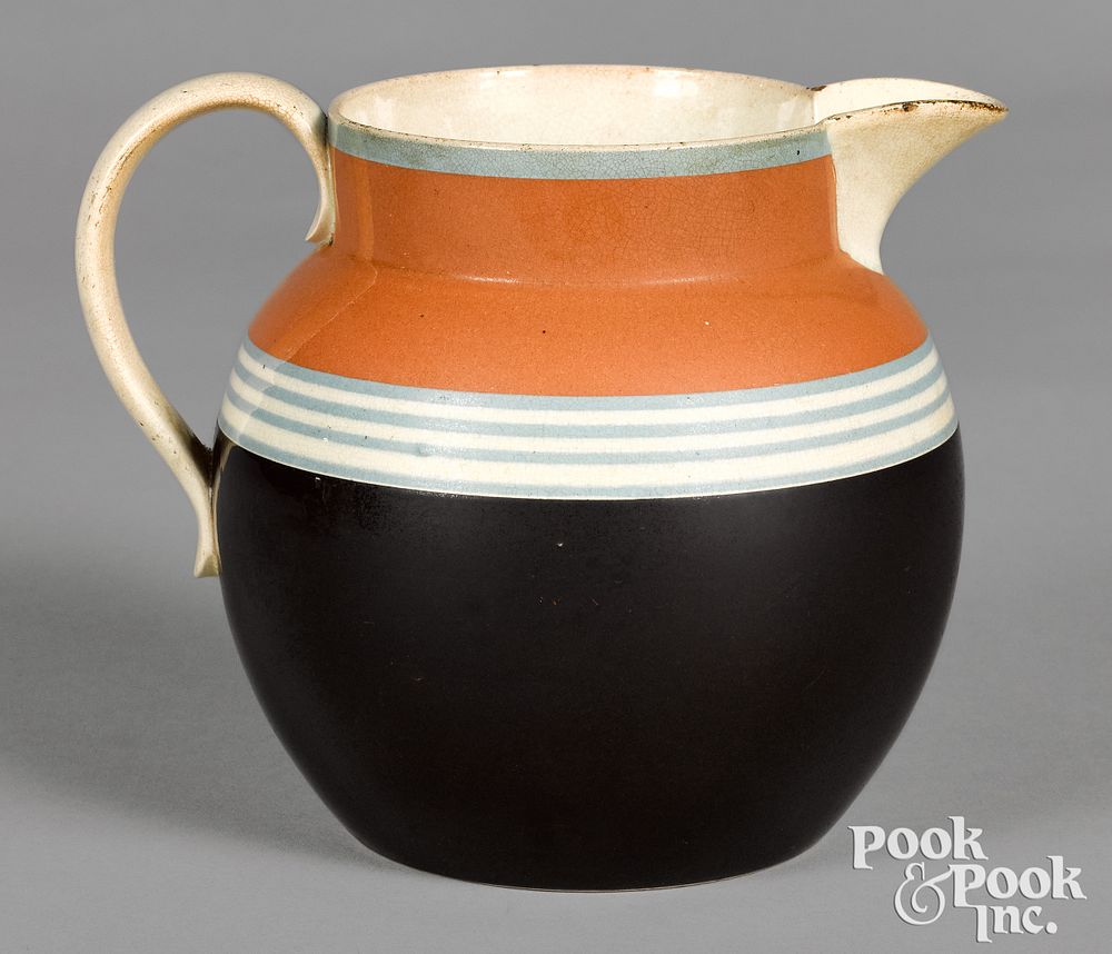 Appraisal: Mocha pitcher Mocha pitcher with brown and tan body and