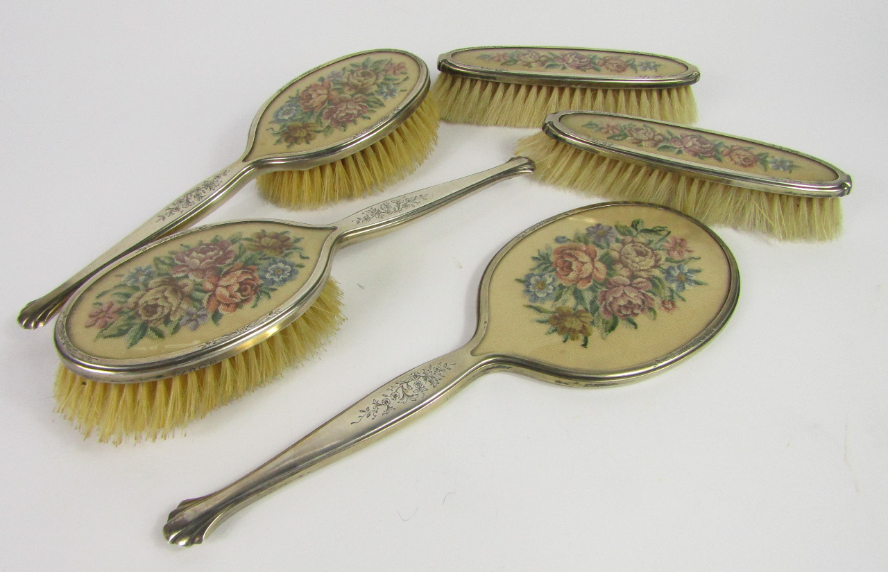 Appraisal: A George VI silver and embroidered floral five piece dressing