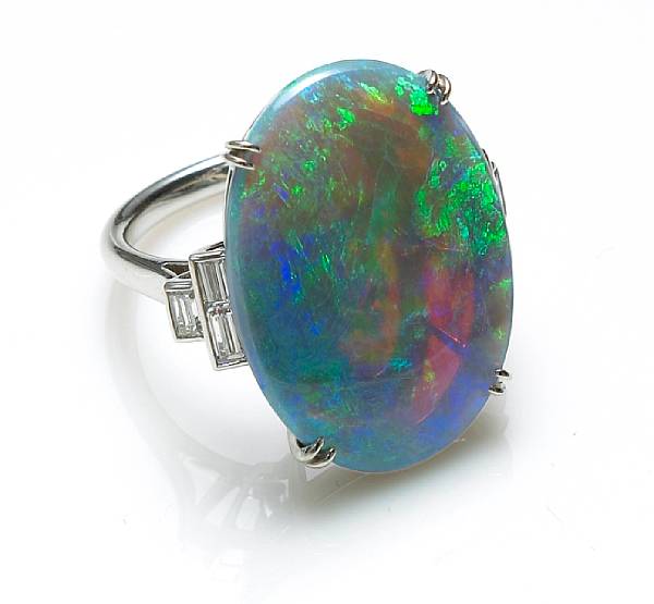 Appraisal: An opal and diamond ring centering an oval-shaped opal measuring