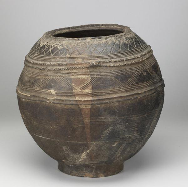 Appraisal: REDWARE POT BURKINA FASO Large spherical vessel with incised decorative