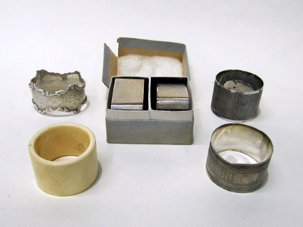 Appraisal: Lot comprising two pairs of silver napkin rings a single