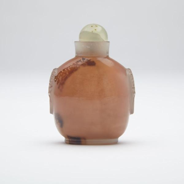 Appraisal: Agate Carved Snuff Bottle The ovoid body flanked by a