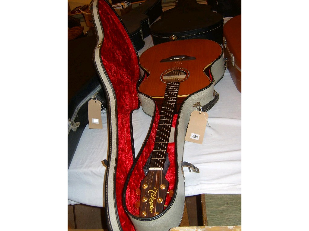 Appraisal: A cased Takamine -string electric guitar with paper label to