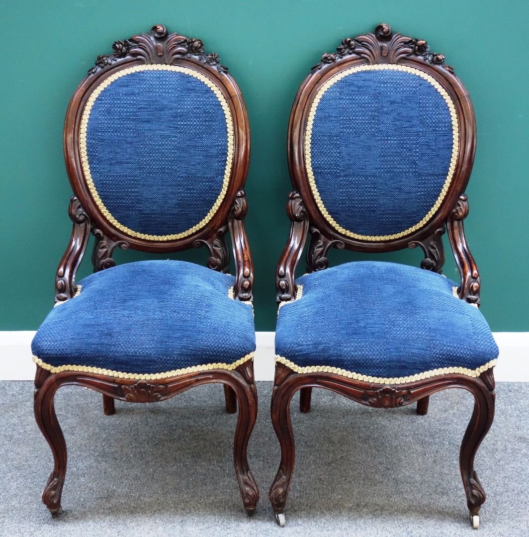 Appraisal: A pair of Victorian carved rosewood side chairs with oval