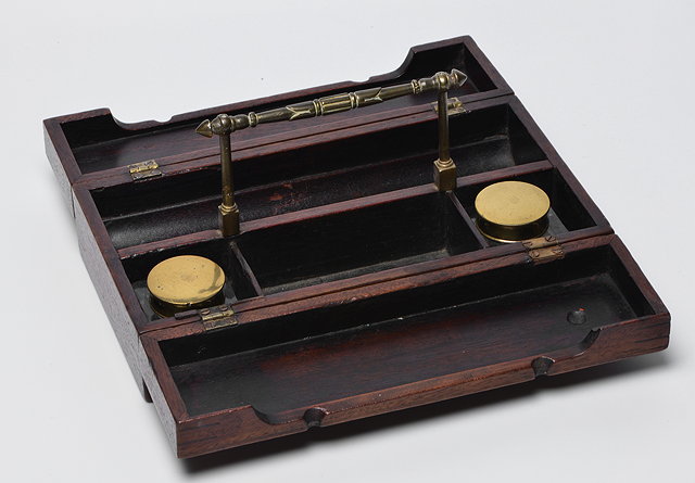 Appraisal: A TH CENTURY MAHOGANY DESK STAND with brass handle fold