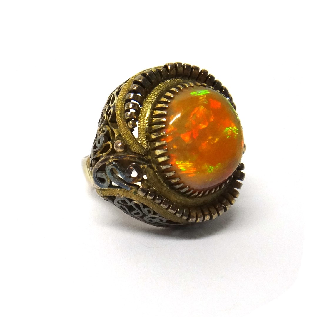 Appraisal: An opal set single stone dress ring in an abstract