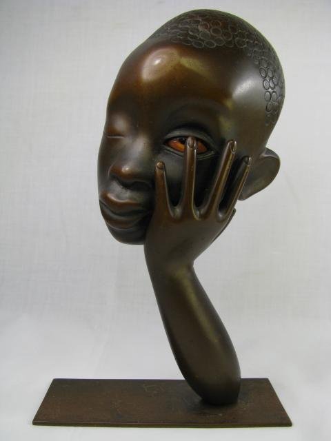 Appraisal: Unusual stylized bust of a young black male holding his