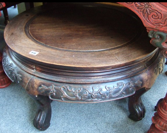 Appraisal: A Chinese hardwood circular low coffee table with a foliate