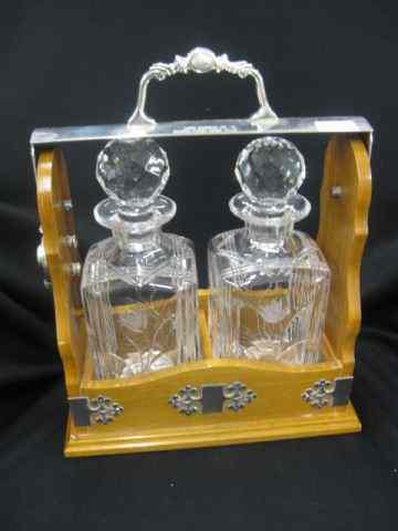 Appraisal: English Tantilus Set two decanters in locking oak holder silverplate