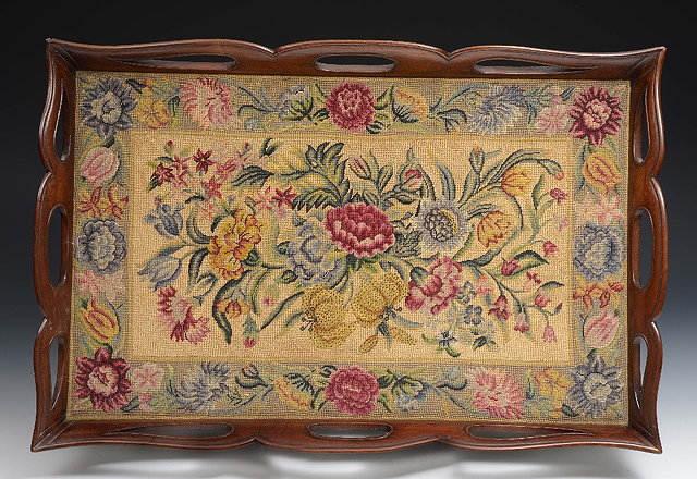 Appraisal: A mahogany rectangular traywith pierced border having an inset needlework