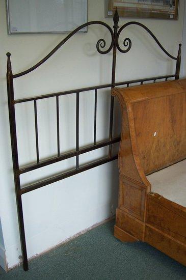 Appraisal: A wrought iron bedhead by Richard Overs with scroll and