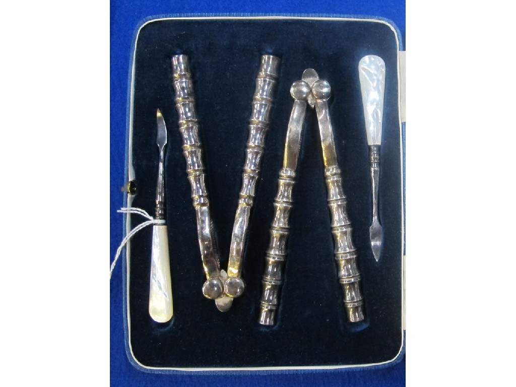 Appraisal: Cased four piece mother of pearl and EP nut cutlery