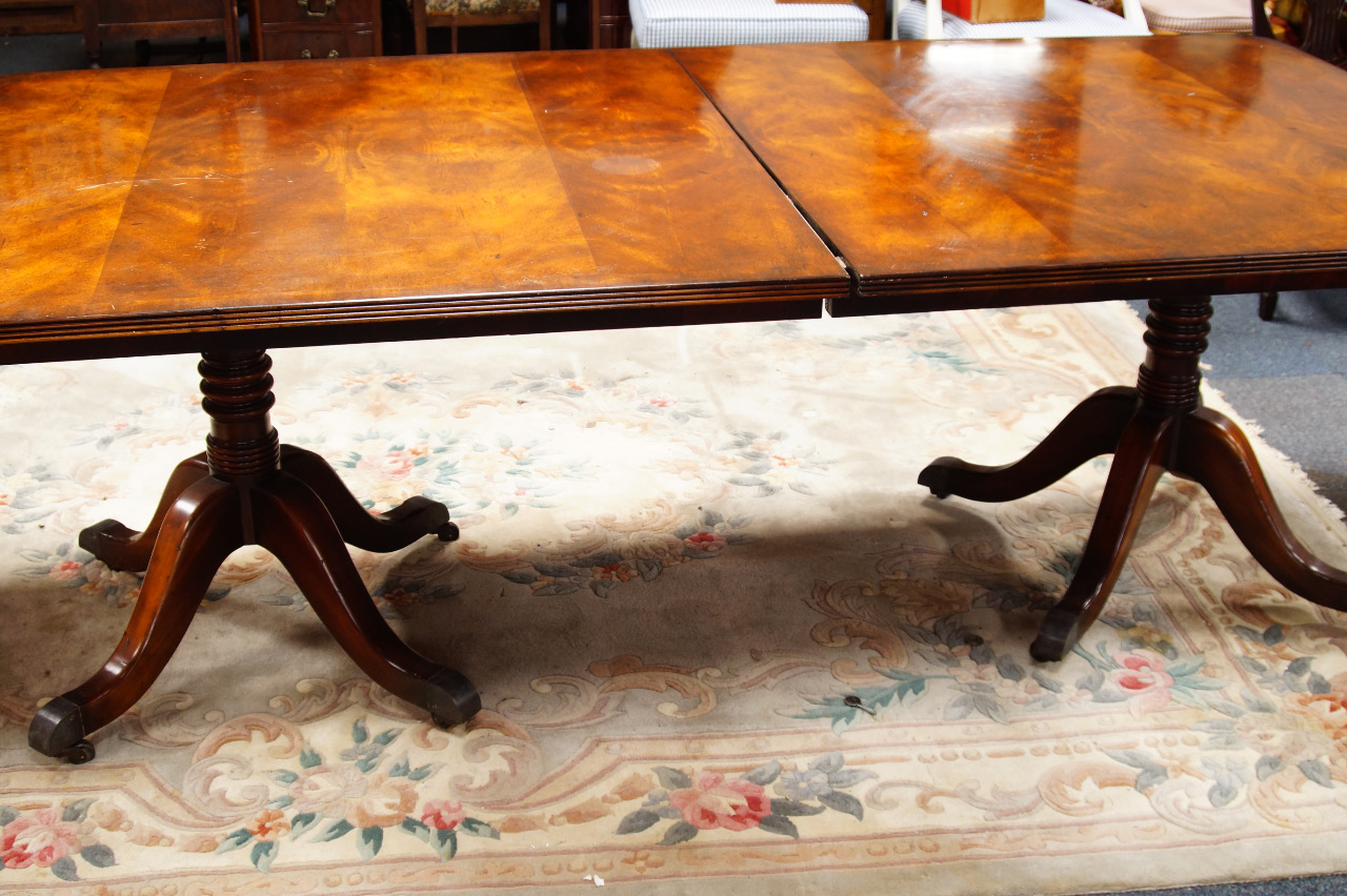 Appraisal: A Regency style solid mahogany twin pedestal dining table with