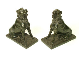 Appraisal: A pair of verde antico seated hounds on rectangular bases