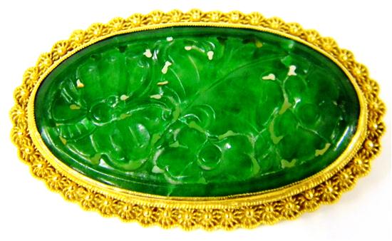 Appraisal: JEWELRY Oval Carved Jade Pin stamped and tested K yellow