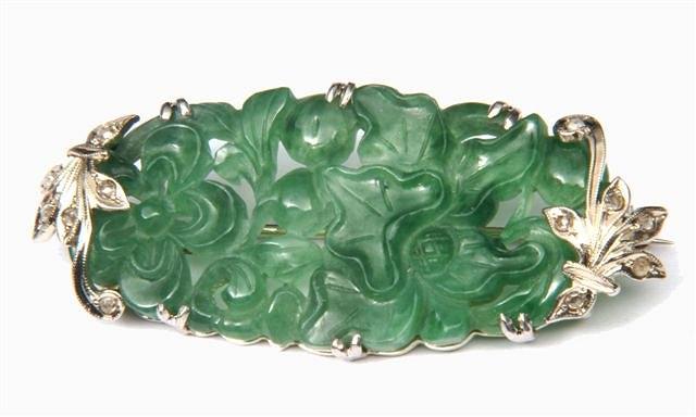 Appraisal: A JADE AND DIAMOND OVAL CARVED BROOCH