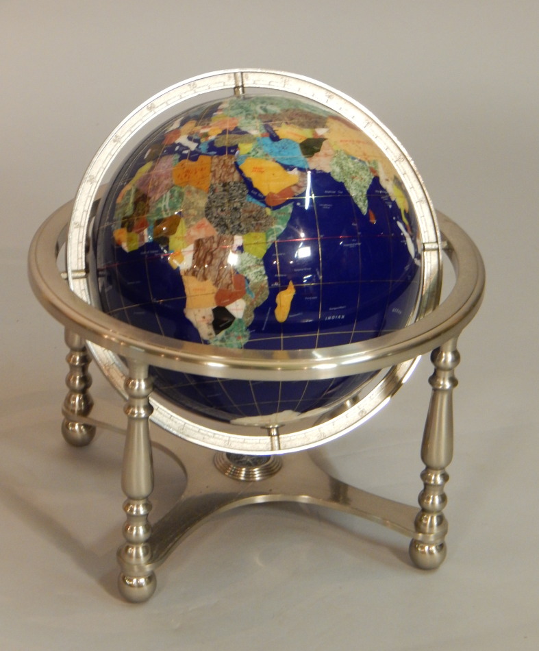 Appraisal: A modern globe inlaid in semi-precious stones on a silvered