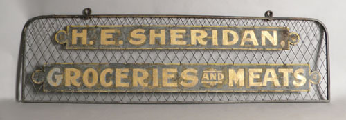 Appraisal: Sheet metal trade sign for E Sheridan Groceries and Meats