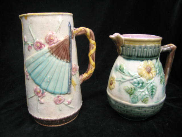 Appraisal: Majolica Pottery Milk Pitchers fan floral motifs