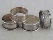 Appraisal: Four near matching hallmarked silver napkin rings being a pair