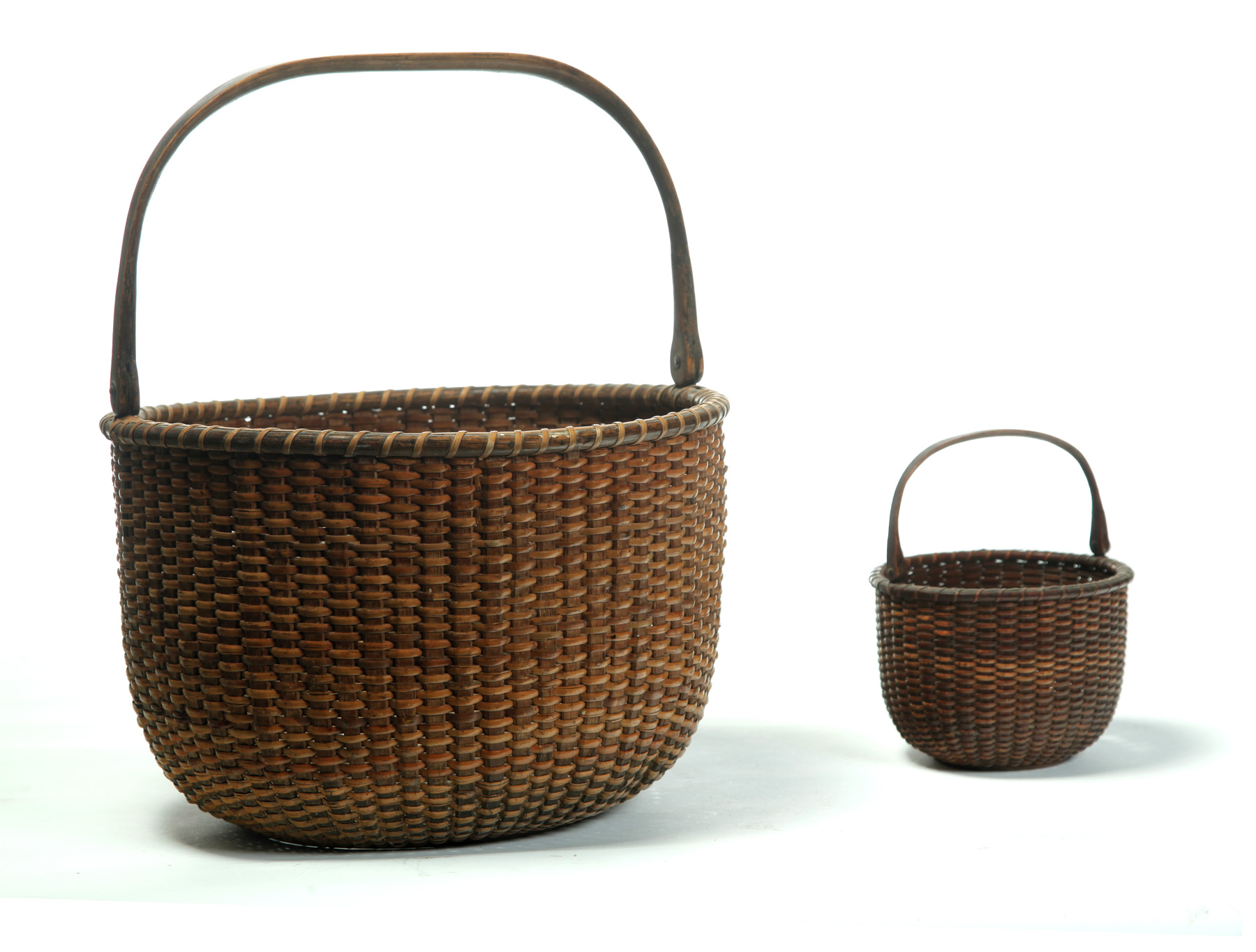 Appraisal: TWO NANTUCKET BASKETS Late th-early th century Woven cane wooden